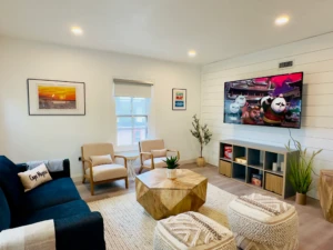 Modern living room with navy sectional and ocean views at dog friendly hotel Cape May NJ