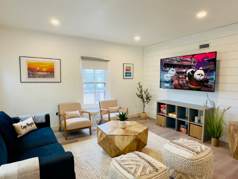 Modern living room with navy sectional and ocean views at dog friendly hotel Cape May NJ