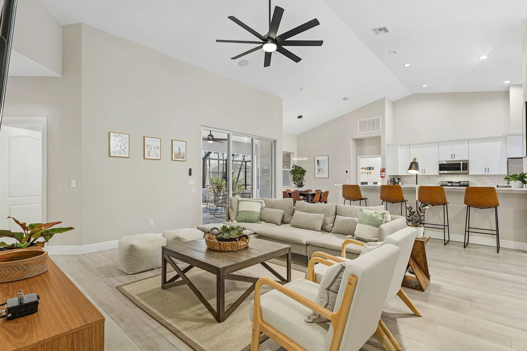 Modern open-concept living room and kitchen with patio access at Cape Pelican