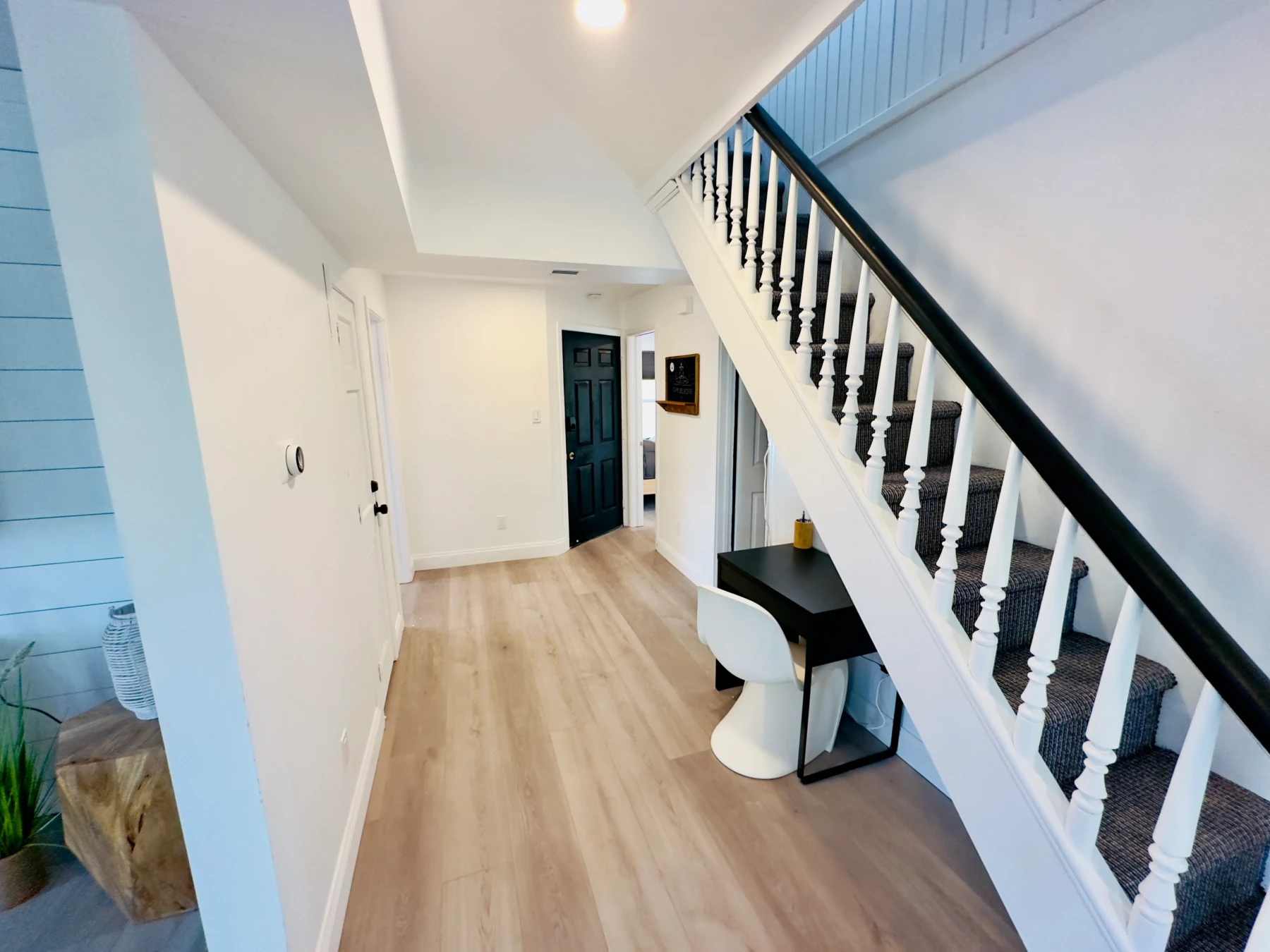 Modern entryway and staircase in a Cape May vacation rental with bright hallway and contemporary design