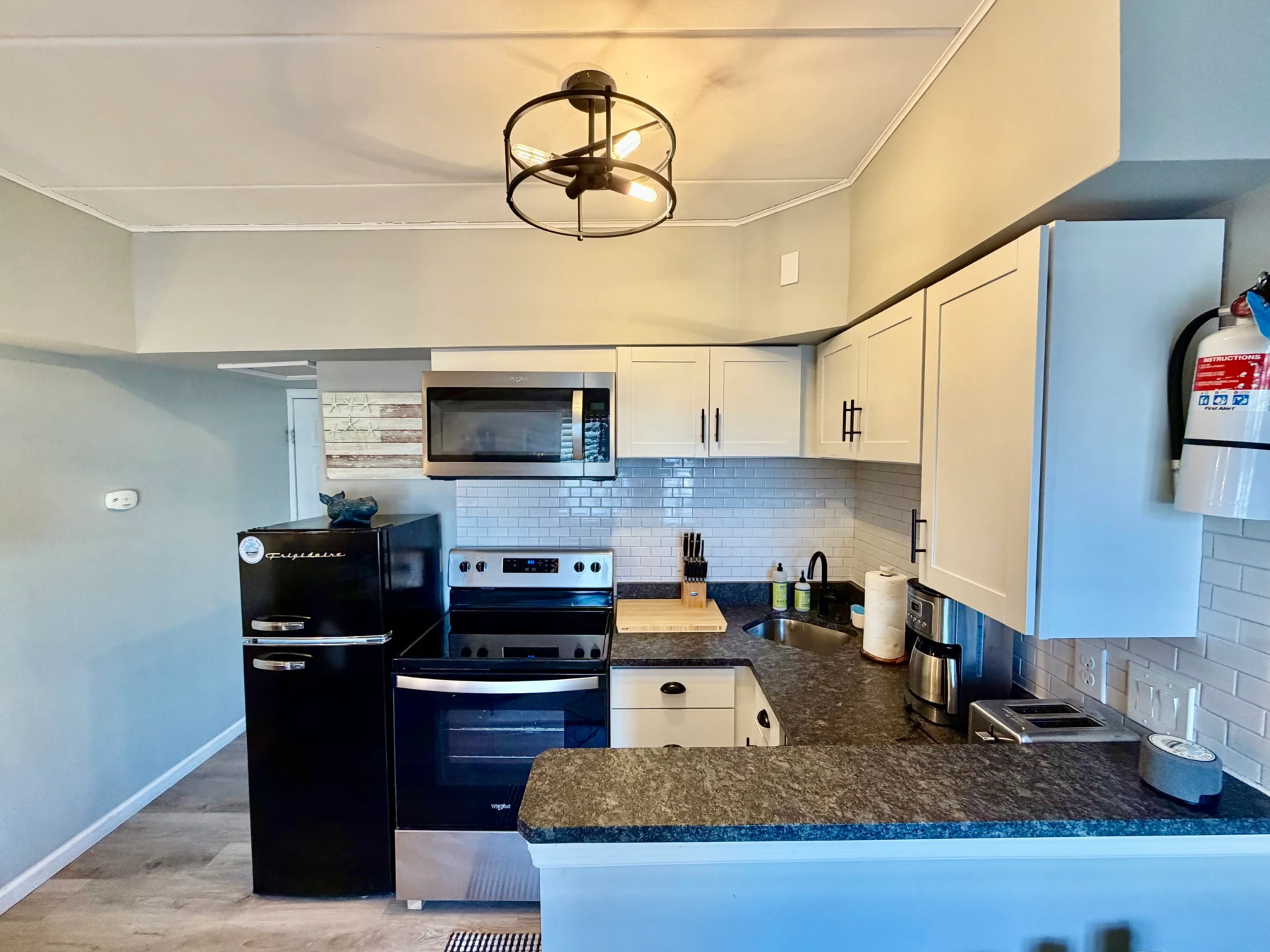 Modern vacation rental kitchen with stainless steel appliances and granite countertops in Cape May