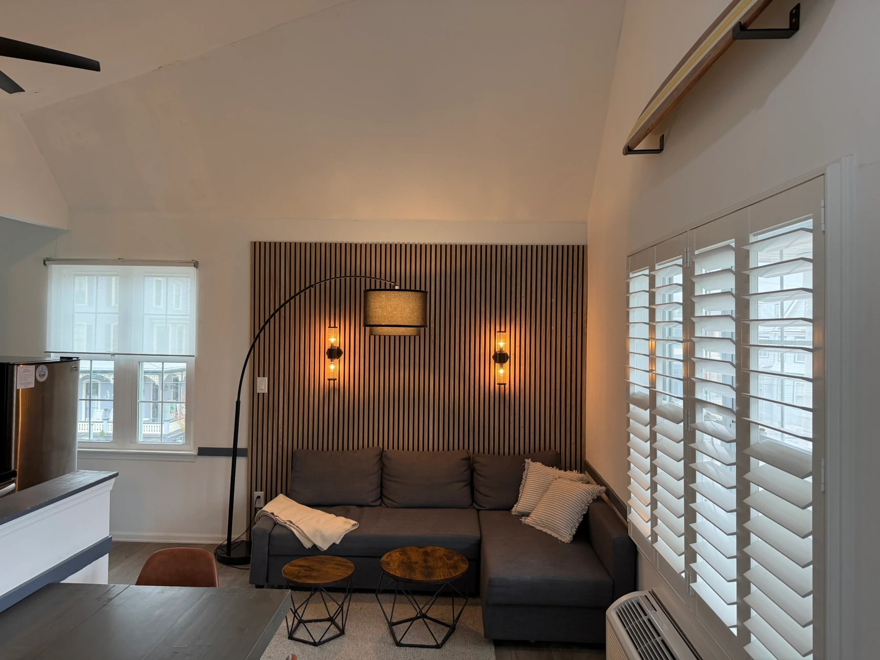 Modern ocean view condo living room with sectional sofa and accent wall in Cape May