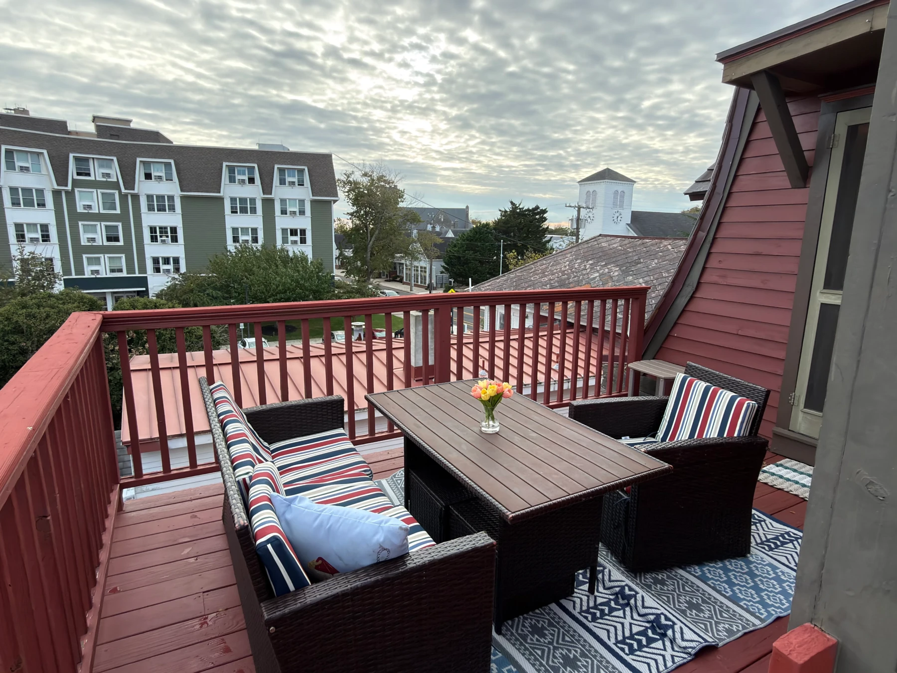 Coastal patio with wicker seating and waterfront view at private villa rental in Cape May